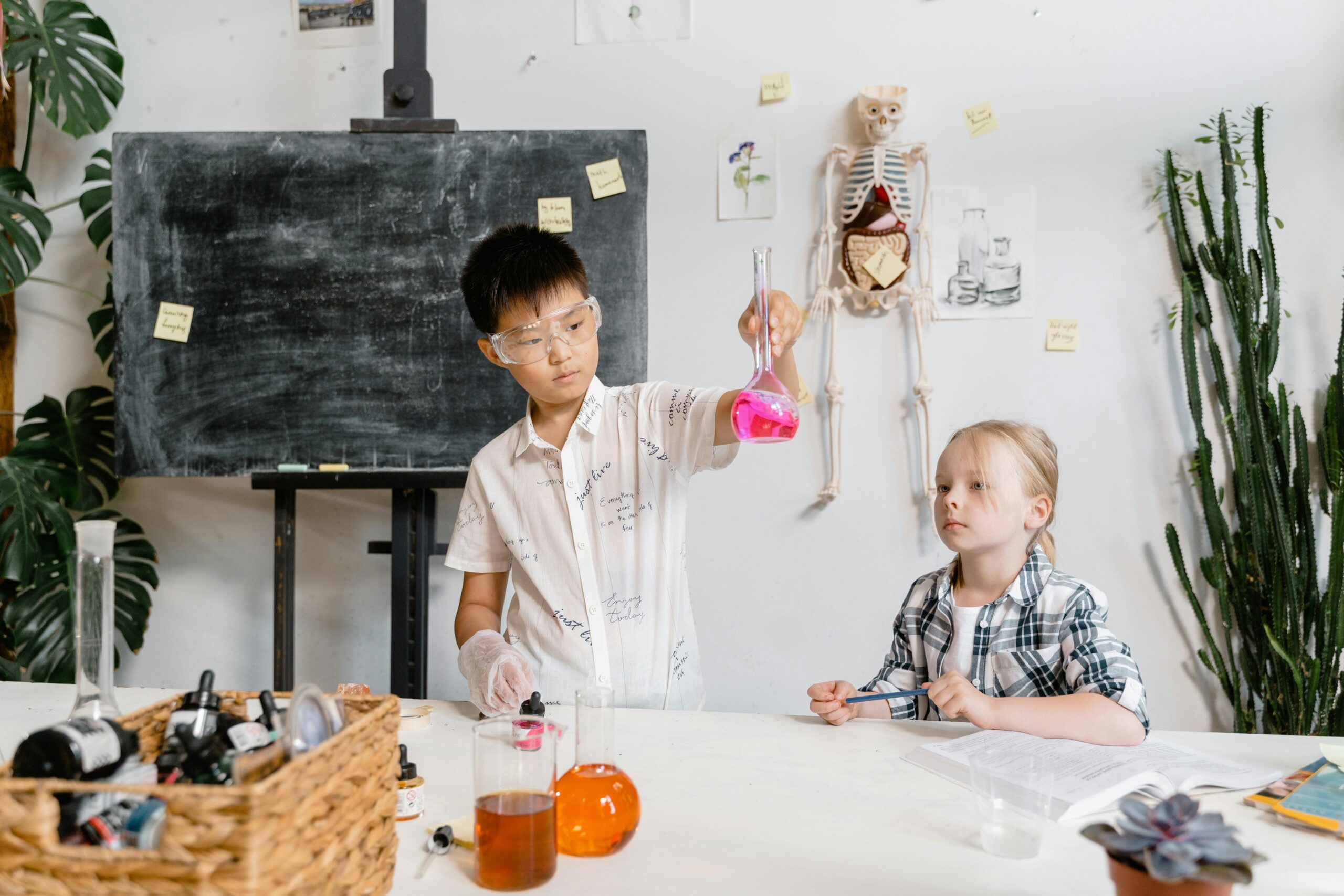 Kids experimenting with lab equipment in a science class, learning about chemistry.